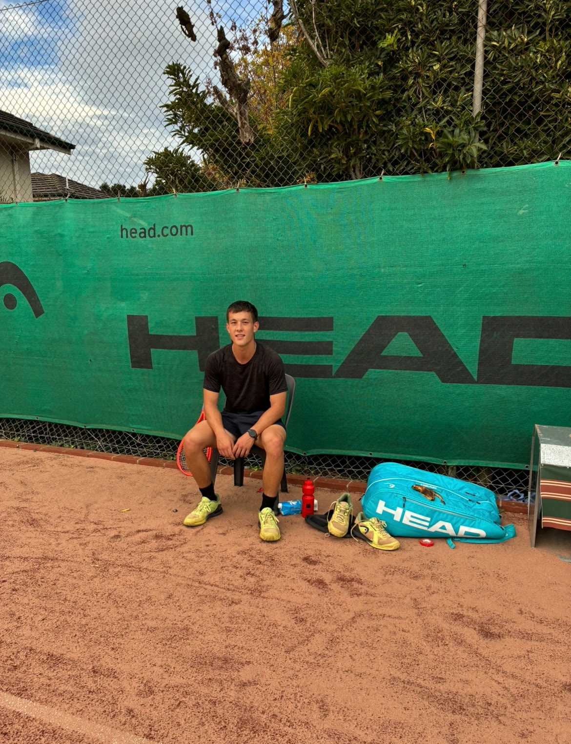 Aidan courtside on the clay at training
