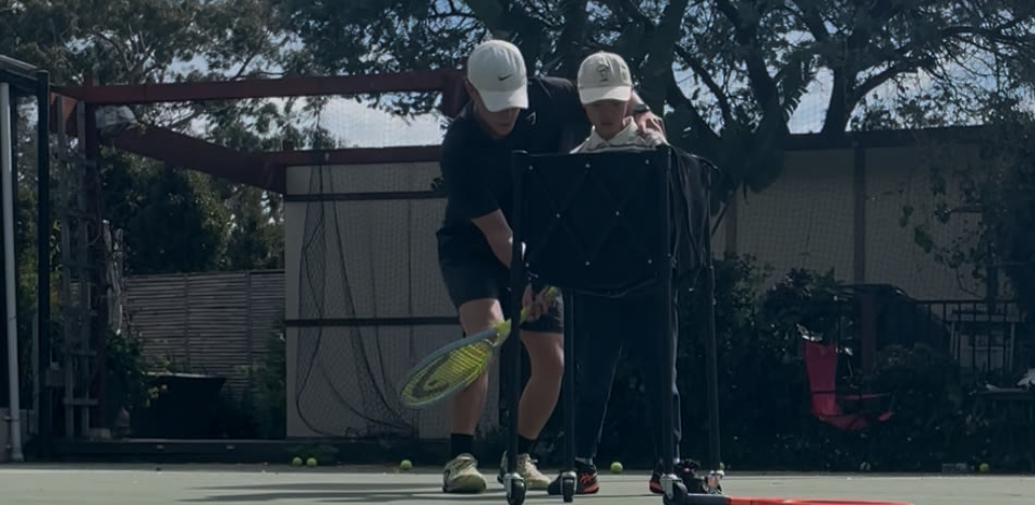 Aidan working with a player at the ball cart