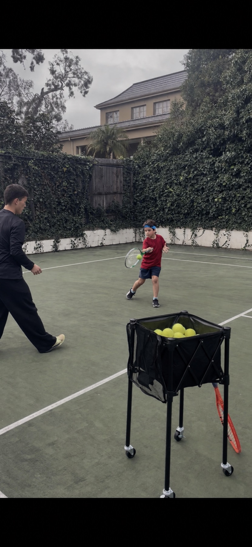 Aidan coaching a junior at the Balwyn North court