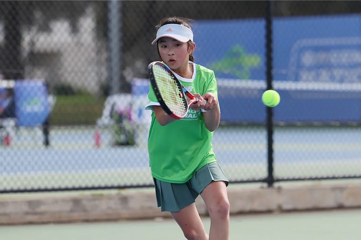 A junior player driving a forehand