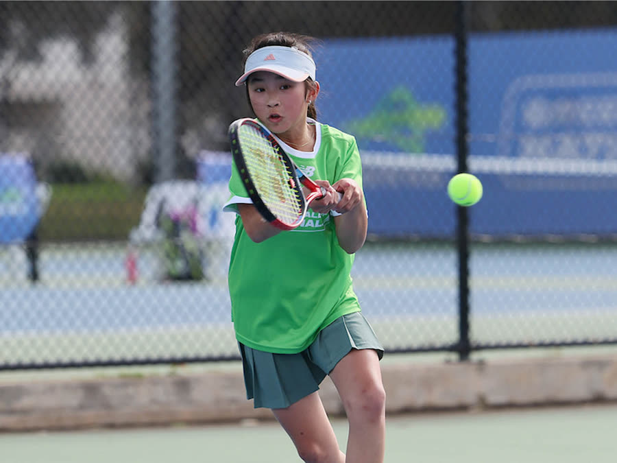 A junior player driving a forehand